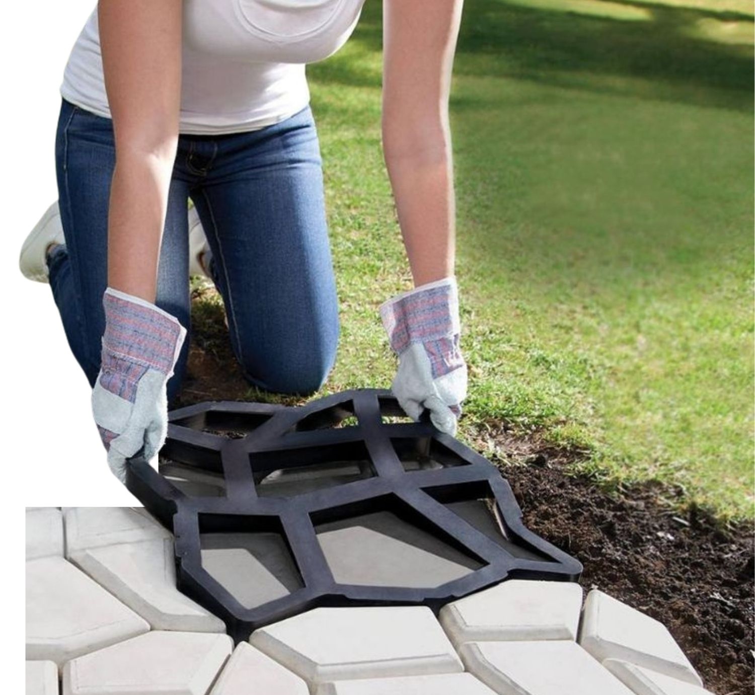 A reusable concrete paver mould laid on a freshly poured garden path